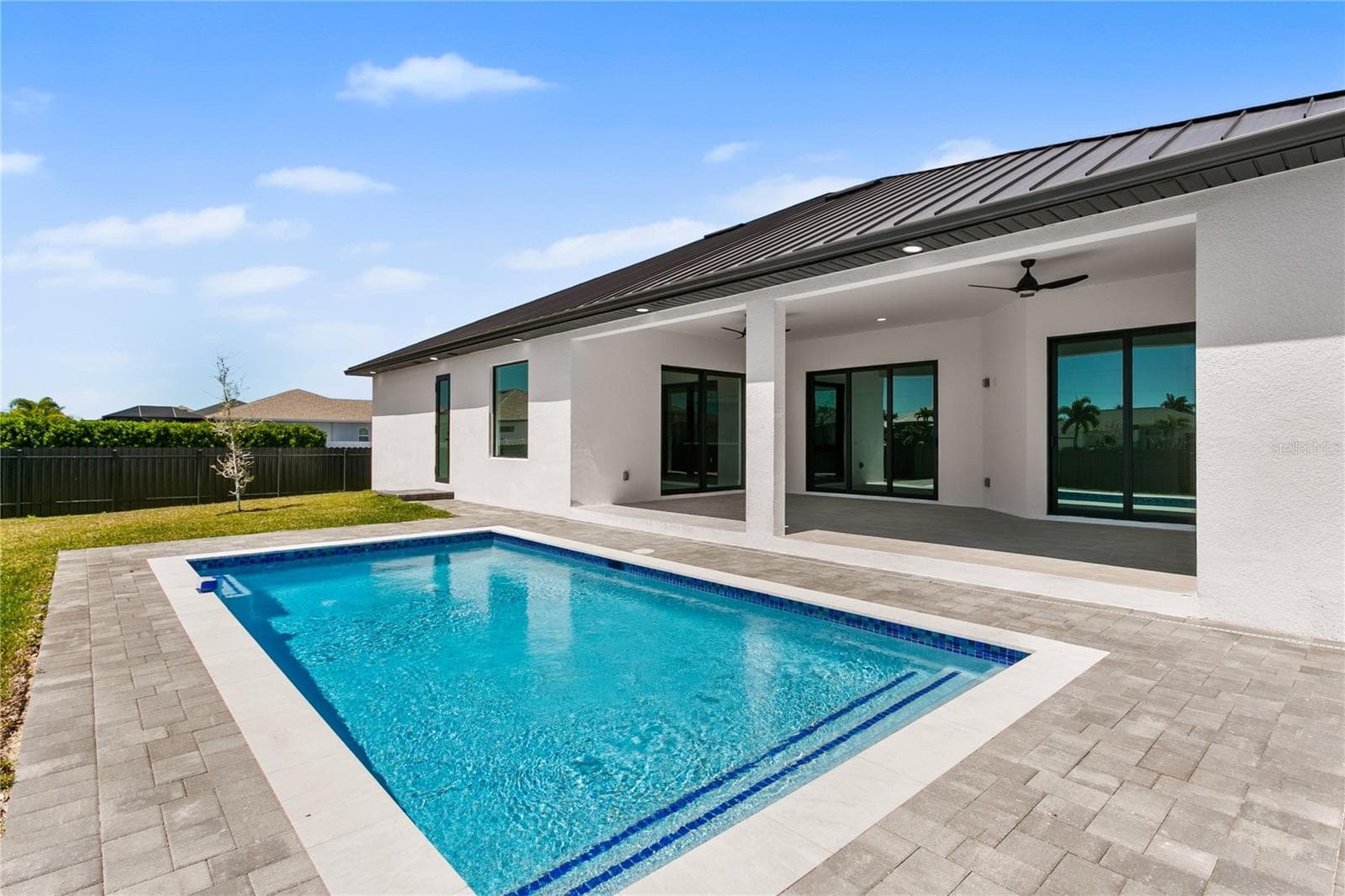 Sparkling pool invites you to cool off and unwind while enjoying the serene outdoor setting - 3300 NW 1ST TER, CAPE CORAL