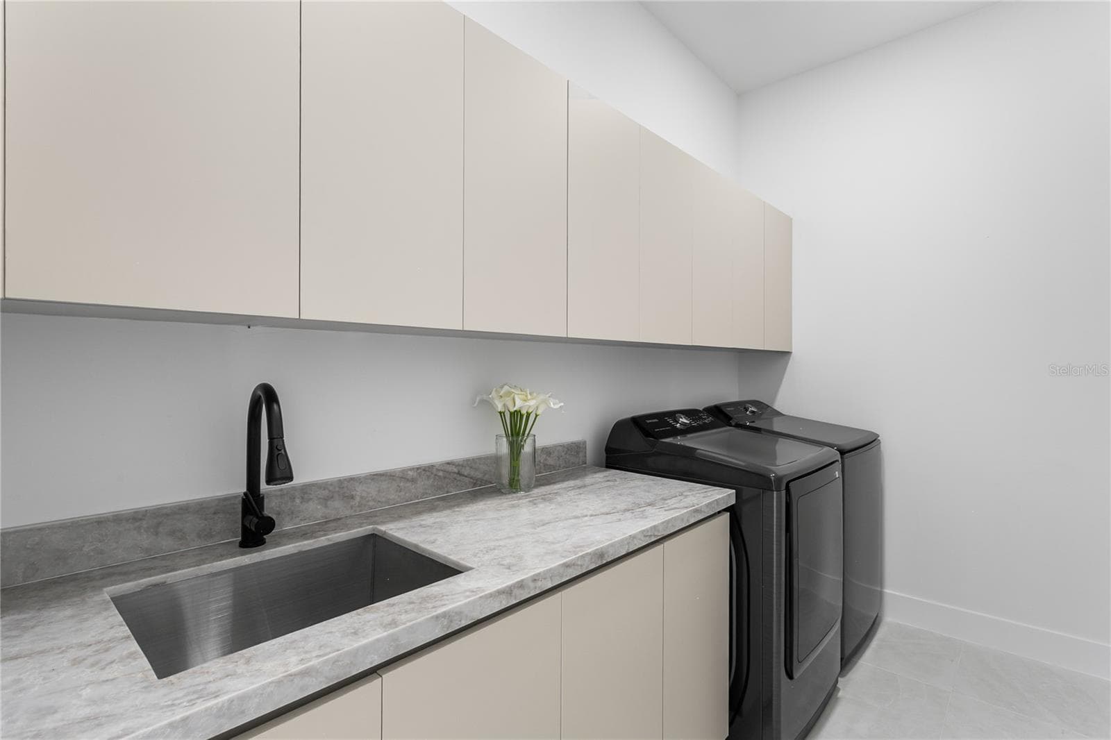 SPACIOUS LAUNDRY w/ SAMSUNG washer & dryer, built-in cabinetry, folding marble counter & utility sink - 3300 NW 1ST TER, CAPE CORAL