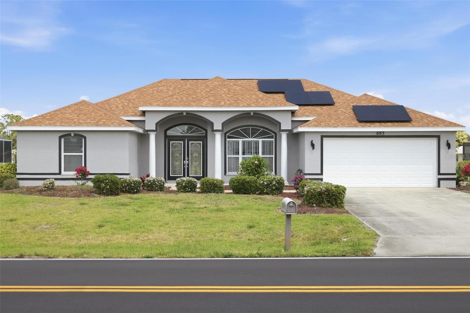 Freshly painted grey exterior on this move-in ready 3/2.5/2 single-family home - 605 ROTONDA CIR, ROTONDA WEST
