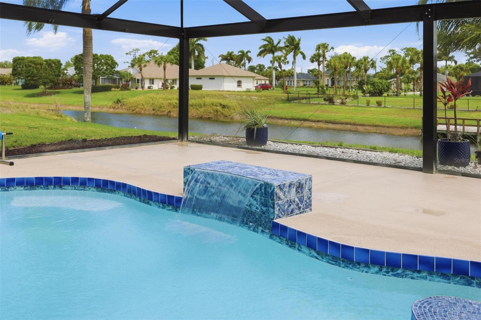 Newly redone chlorine pool (2025) with resort-style screened enclosure and ample deck - 605 ROTONDA CIR, ROTONDA WEST