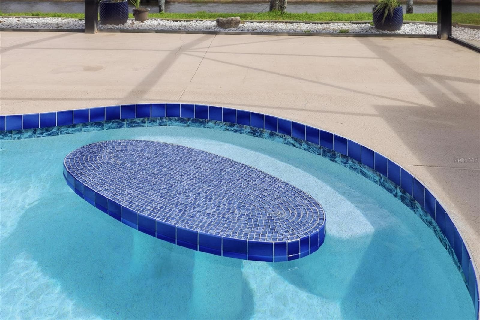 Beautiful newly resurfaced pool (2025) with elegant coping and lush backyard views - 605 ROTONDA CIR, ROTONDA WEST