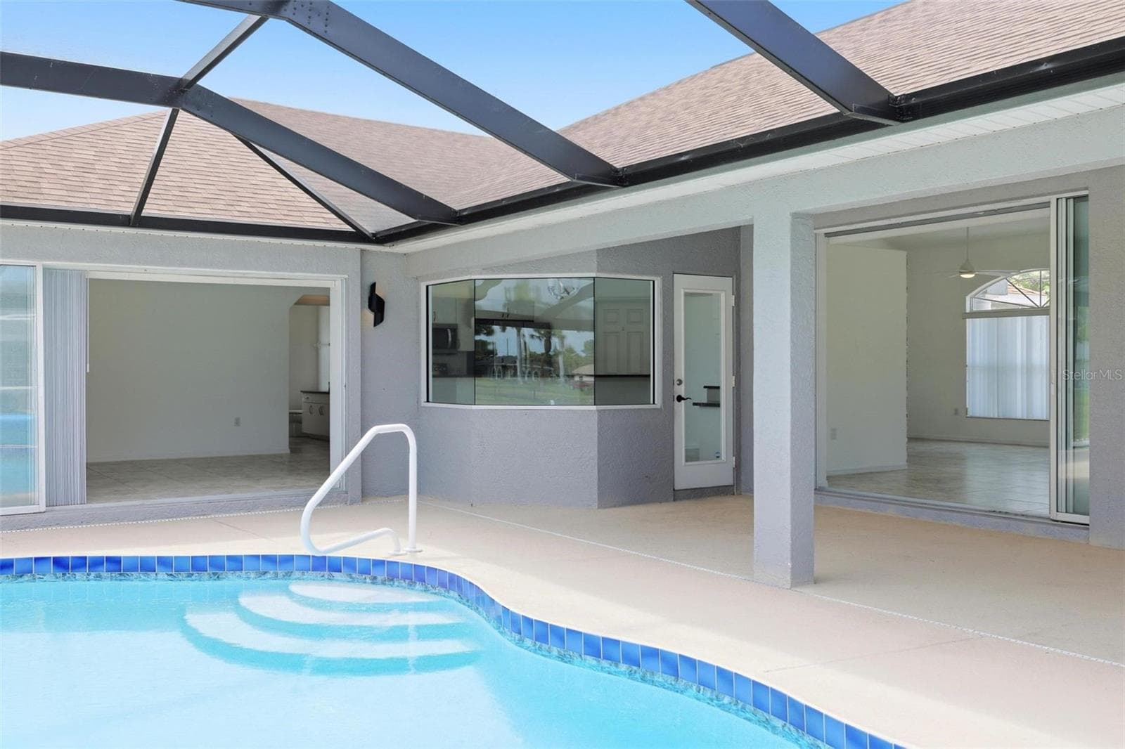 Serene heated pool area with 2024 pool heater and beautiful natural light - 605 ROTONDA CIR, ROTONDA WEST