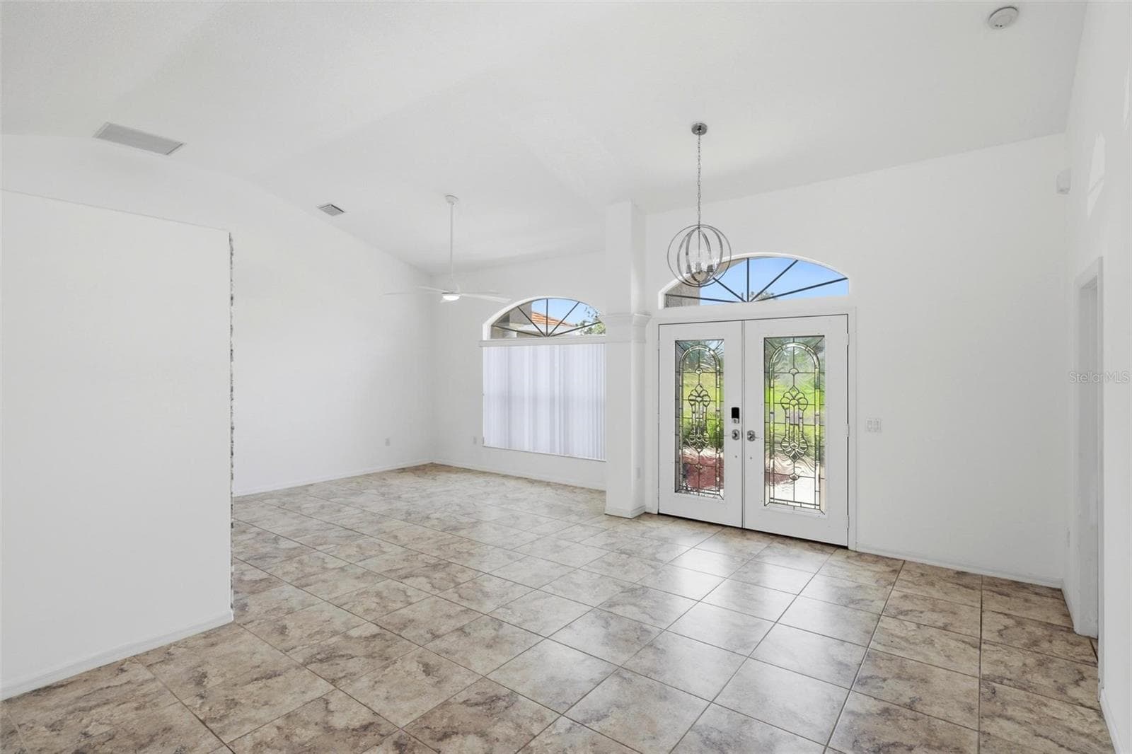 Open room with large windows, tile flooring, and clean move-in ready finishes - 605 ROTONDA CIR, ROTONDA WEST