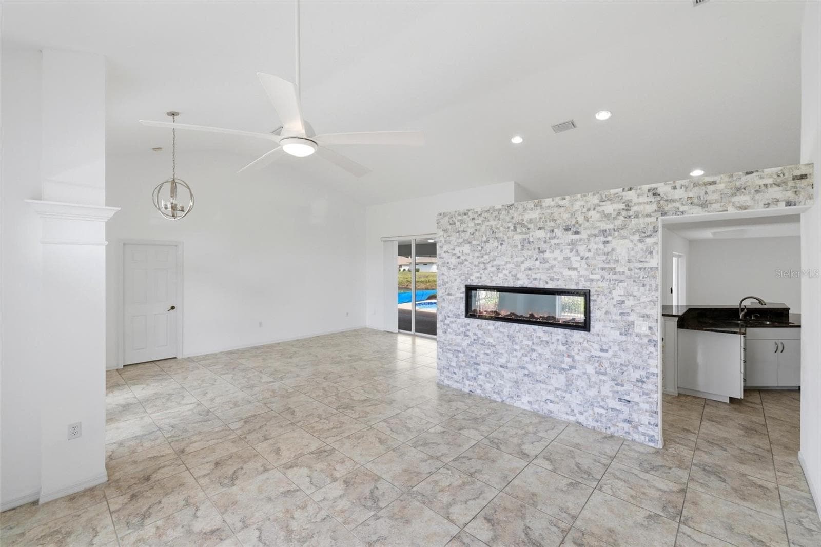Open living space with tile floors, recessed lighting, and clean neutral tones - 605 ROTONDA CIR, ROTONDA WEST