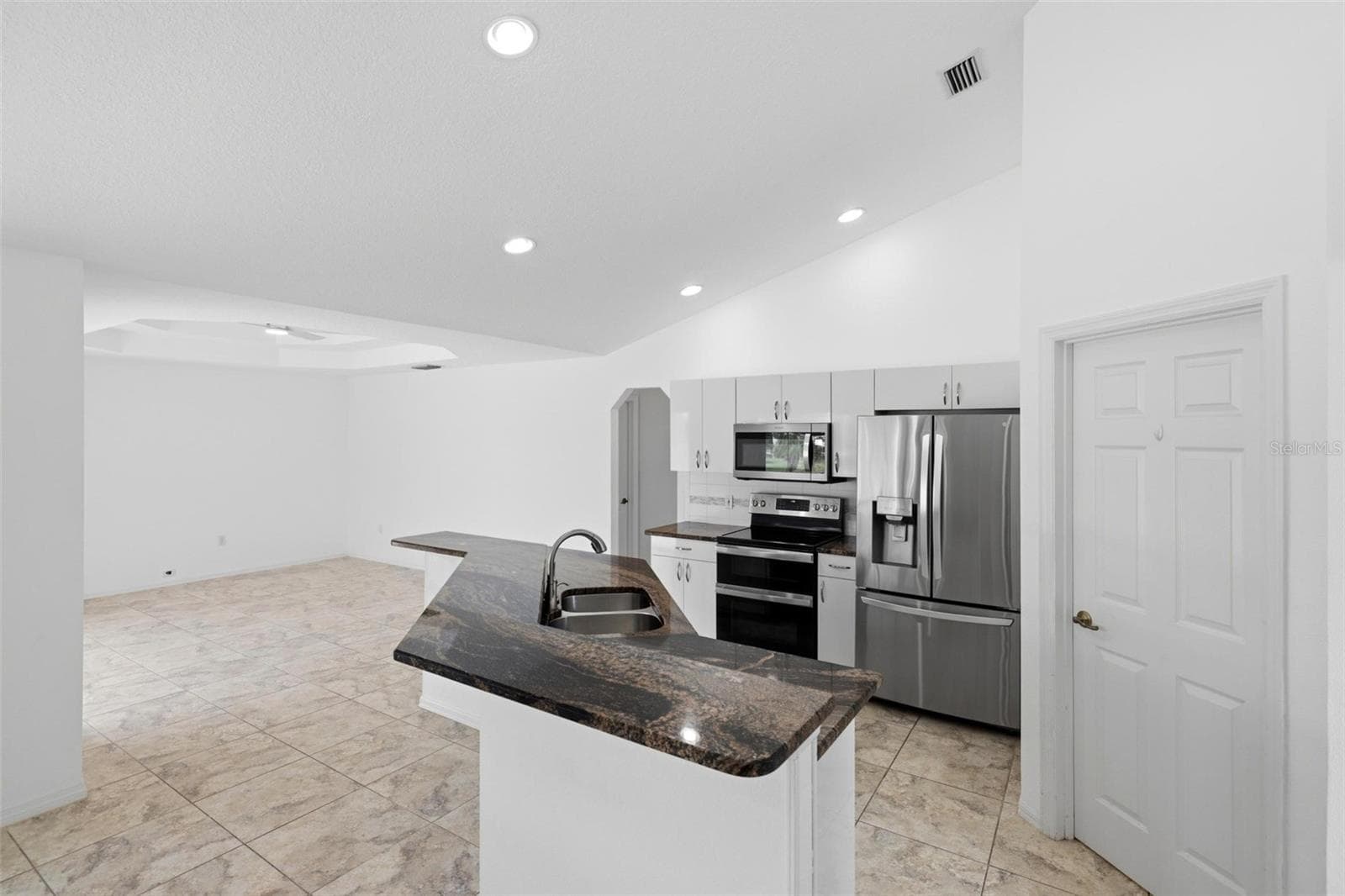 Well-appointed kitchen with new 2024 microwave, dark counters, and recessed lighting - 605 ROTONDA CIR, ROTONDA WEST