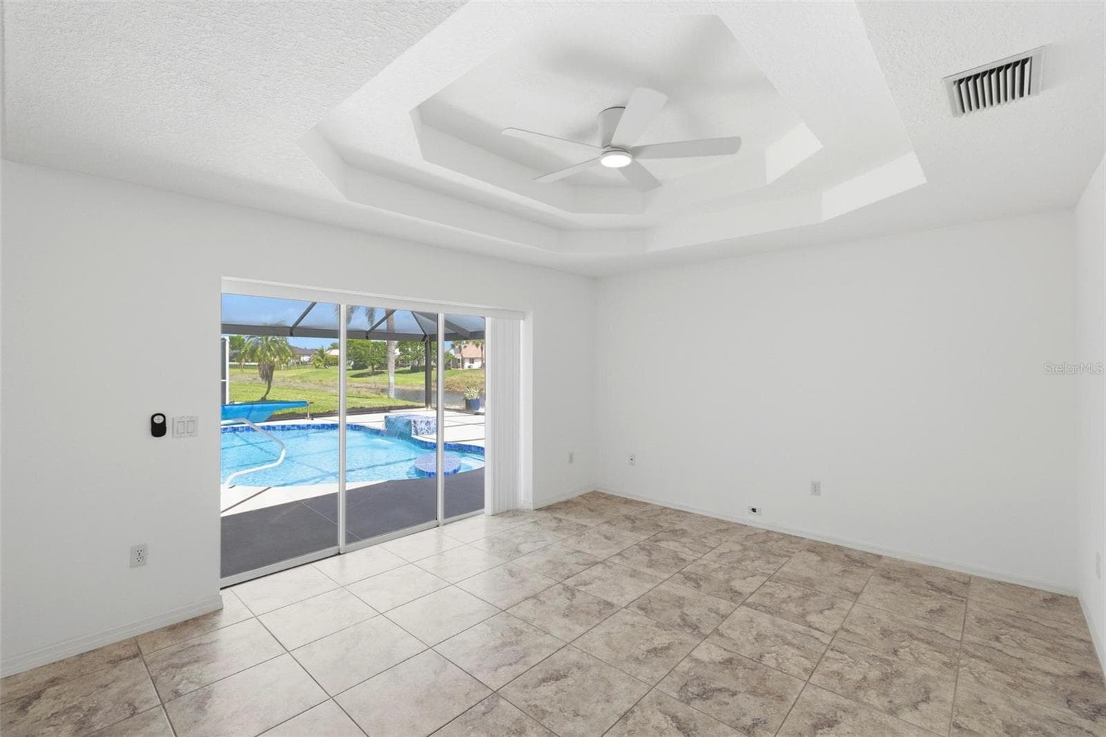 Bright living and sitting area just off the kitchen with coffered ceiling and recessed lightin - 605 ROTONDA CIR, ROTONDA WEST