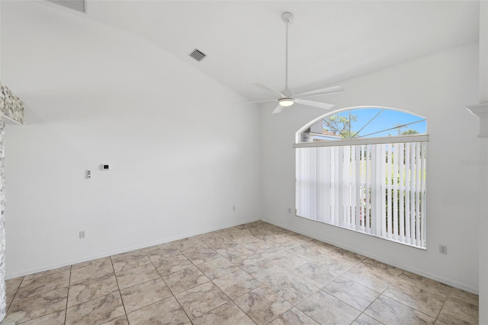 Large open room with tile floors, abundant natural light, and move-in ready finishes - 605 ROTONDA CIR, ROTONDA WEST