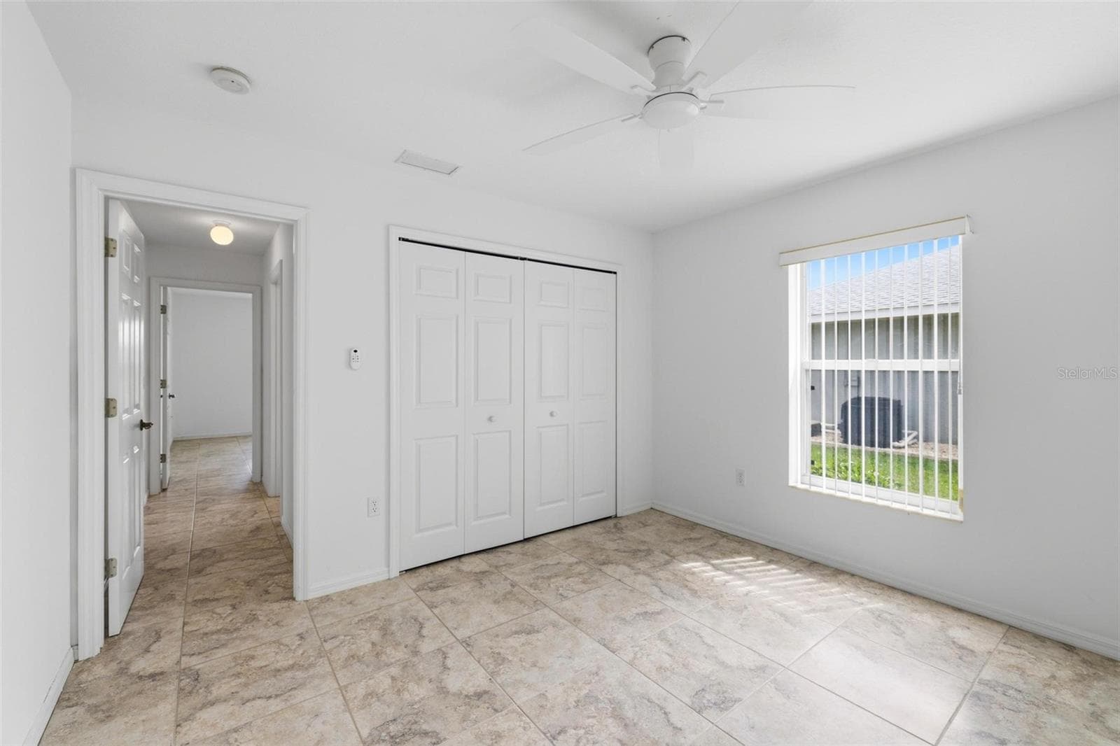 Spacious bedroom with large window, neutral tones, and move-in ready condition - 605 ROTONDA CIR, ROTONDA WEST