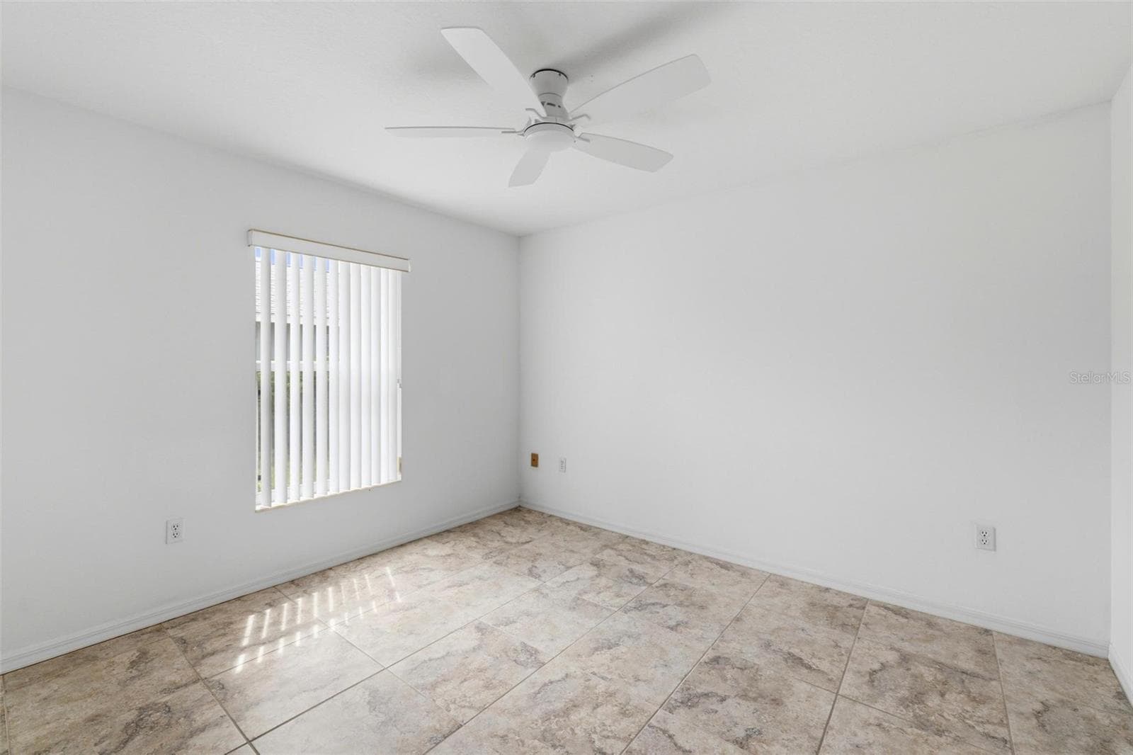 Generously sized bedroom with ceiling fan, neutral paint, and abundant natural light - 605 ROTONDA CIR, ROTONDA WEST