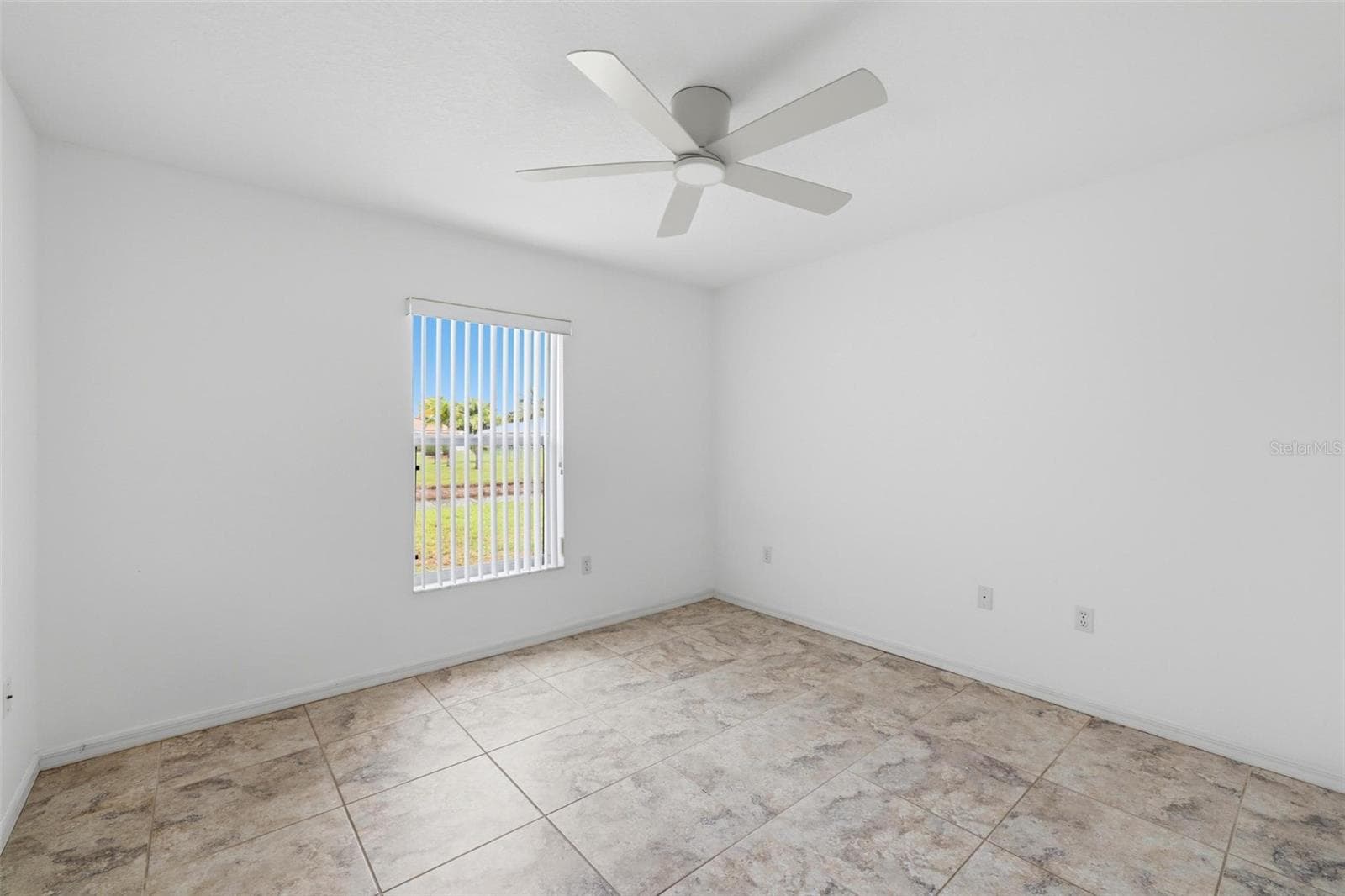 Bright bedroom with large window, ceiling fan, and open, airy feel - 605 ROTONDA CIR, ROTONDA WEST