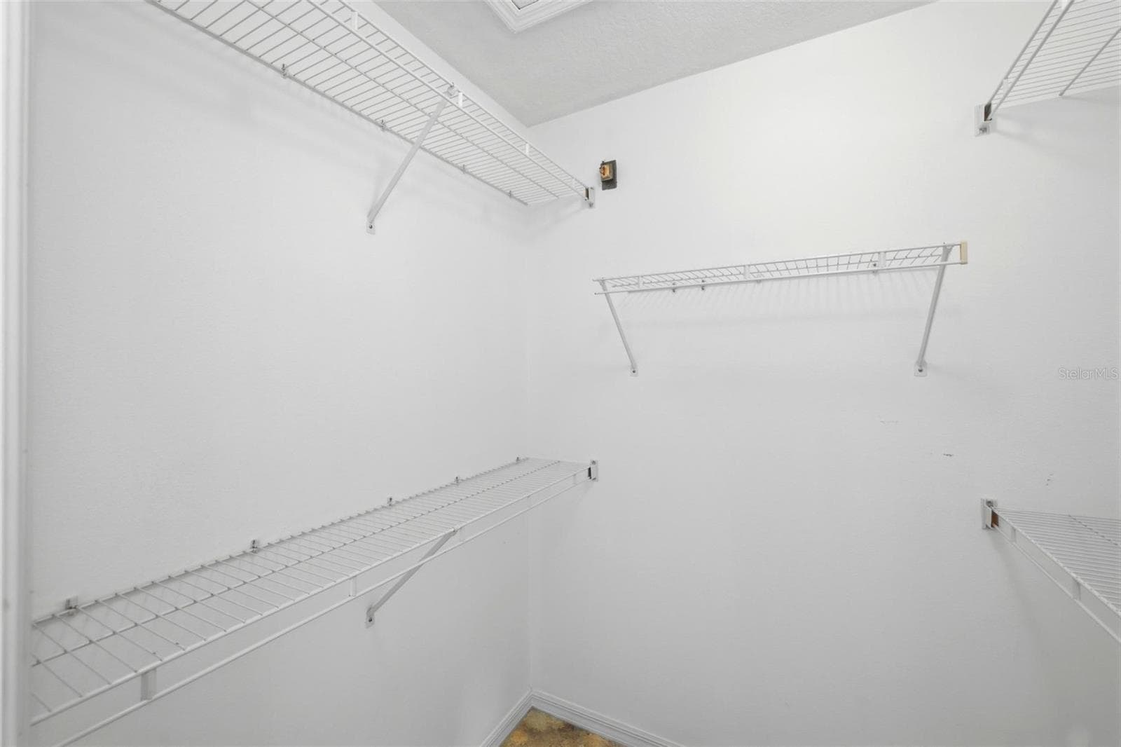 Large walk-in closet with rod and shelf system, ready for your personal touch - 605 ROTONDA CIR, ROTONDA WEST
