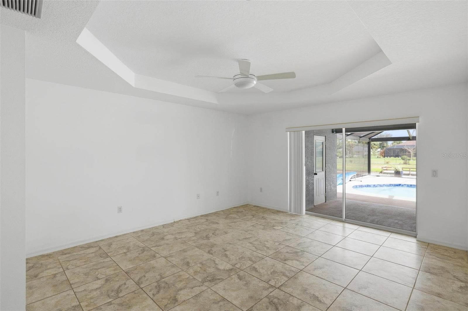 Airy bedroom with sliding glass door access and open, welcoming feel - 605 ROTONDA CIR, ROTONDA WEST