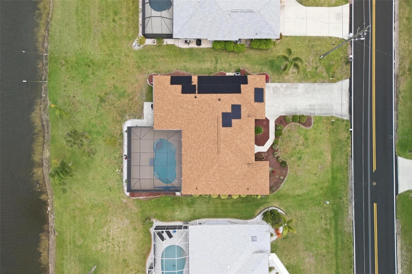 Aerial view showing tile roof (replaced 2023), pool enclosure, and generous lot size - 605 ROTONDA CIR, ROTONDA WEST