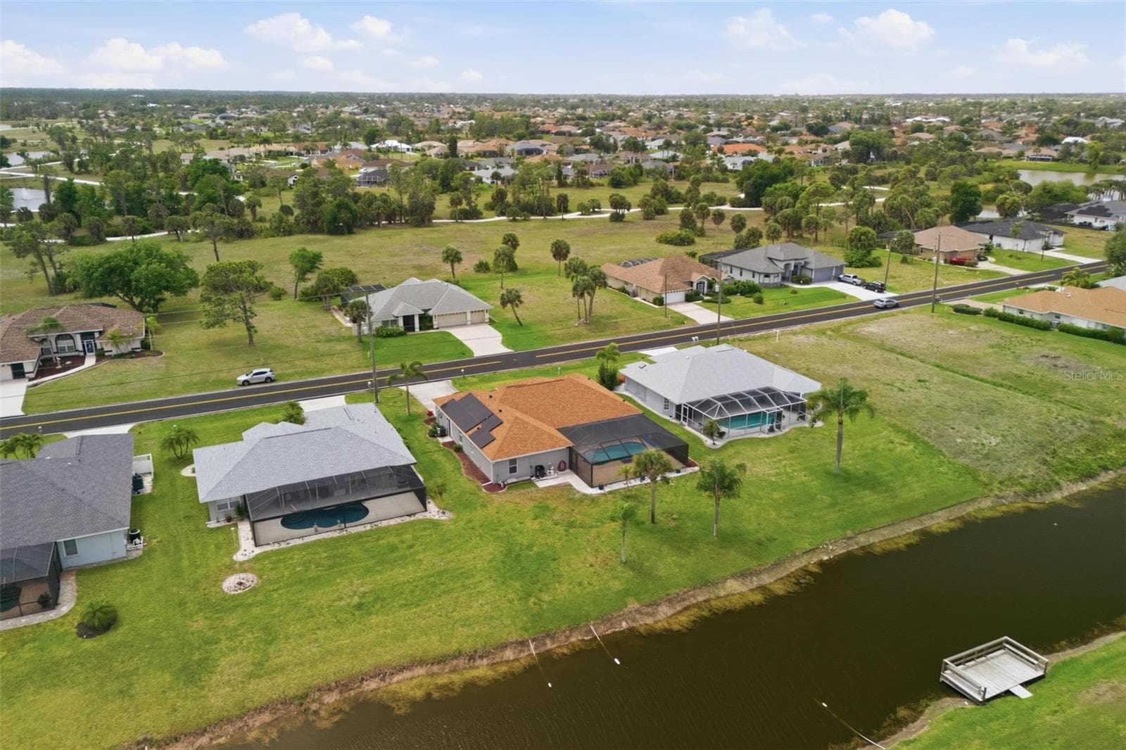 Overhead view of property showing pool enclosure, 2023 roof, and spacious backyard - 605 ROTONDA CIR, ROTONDA WEST