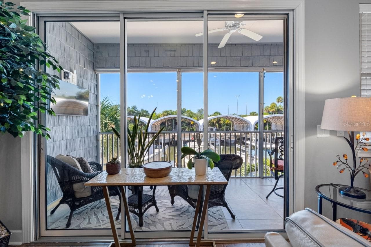 Balcony with a mounted TV and water views. Enjoy your morning coffee while gazing out at what could be your own ?? boat sitting there waiting for you. - 6057 MOORINGS DR S, ST PETERSBURG
