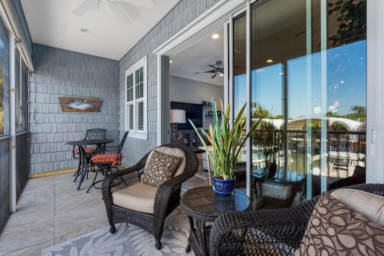 Balcony with a mounted TV and water views. Enjoy your morning coffee while gazing out at what could be your own ?? boat sitting there waiting for you. - 6057 MOORINGS DR S, ST PETERSBURG