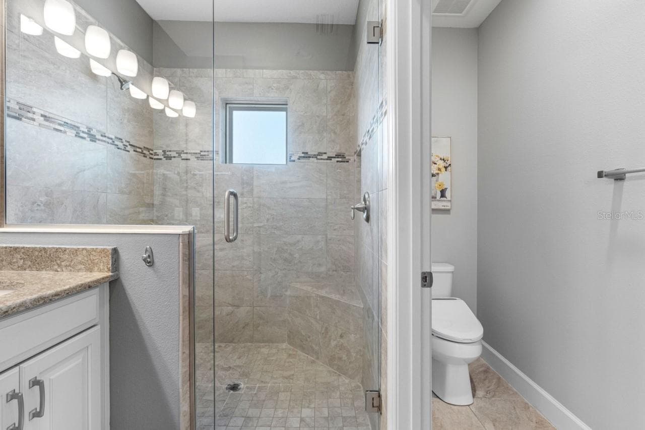 Split layout, with the toilet tucked into its own private water closet for added privacy and comfort. - 6057 MOORINGS DR S, ST PETERSBURG