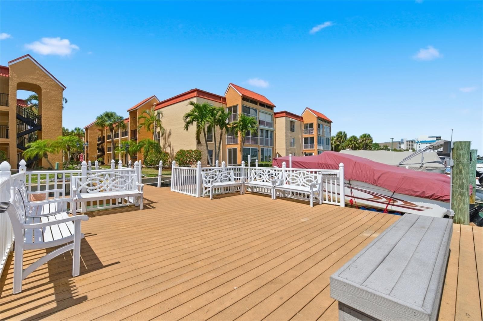 benches at the fishing dock for hanging out with neighbors - 8901 BLIND PASS RD #127, ST PETE BEACH