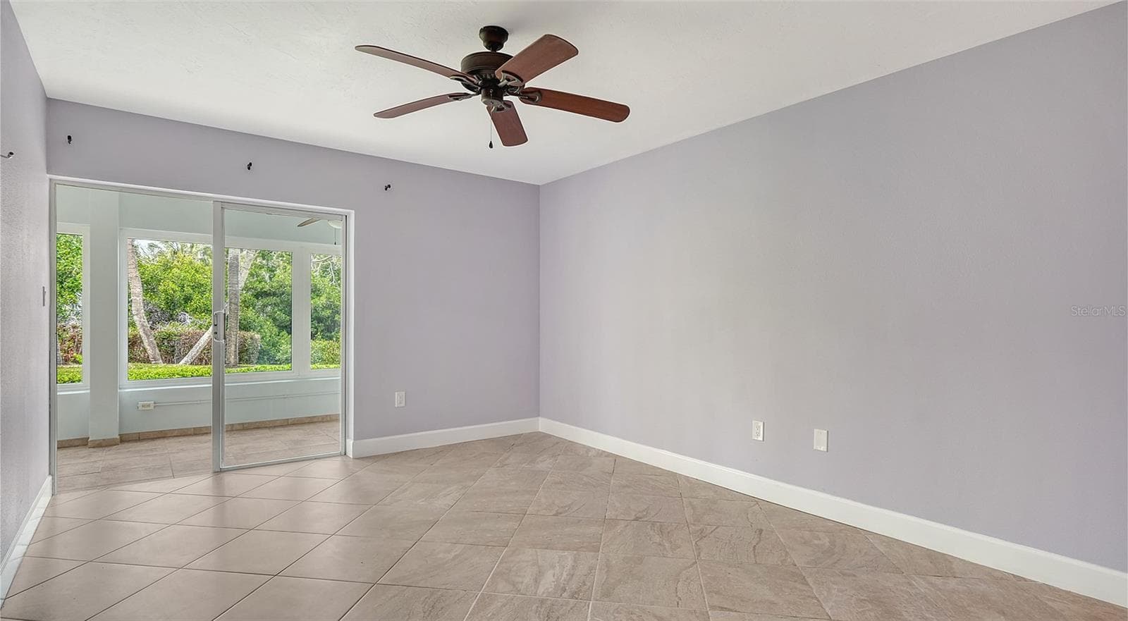 Primary bedroom with sliders leading to the lanai. - 225 HOURGLASS WAY #106, SARASOTA