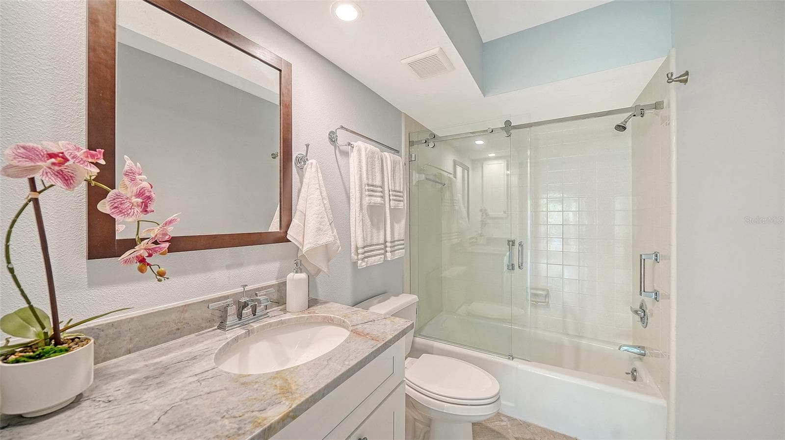 Guest bathroom with granite countertop and glassed shower/tub combination. - 225 HOURGLASS WAY #106, SARASOTA