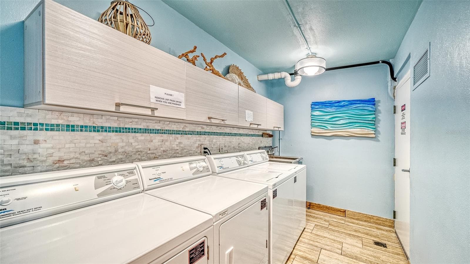 Two NEW sets of washers and dryers in the common laundry room serving just 6 units on the floor. - 225 HOURGLASS WAY #106, SARASOTA