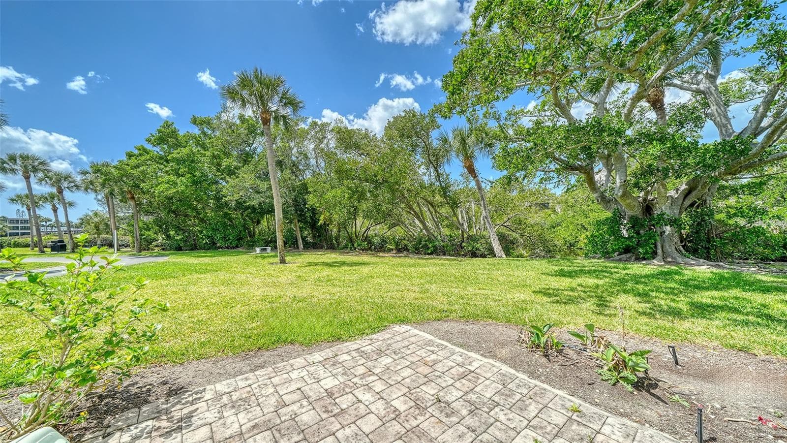 The small brick patio off the lanai is great for grilling or relaxing after a day at the beach. - 225 HOURGLASS WAY #106, SARASOTA