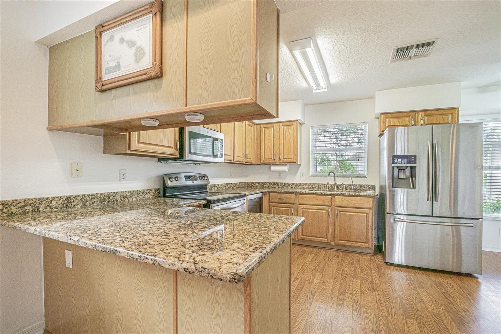 Breakfast bar in this functional kitchen! - 11204 COREY PAVIN LN, SAN ANTONIO