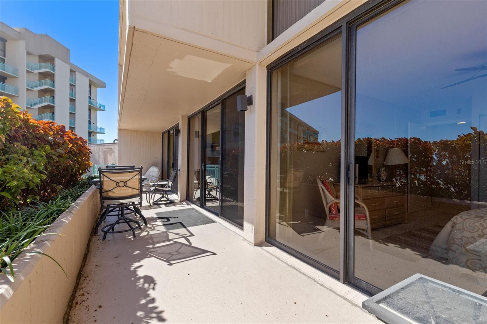 View from Guest Br to Living Room and Master Br windows - all with access to this balcony / patio or terrace - 1 KEY CAPRI #102E, TREASURE ISLAND
