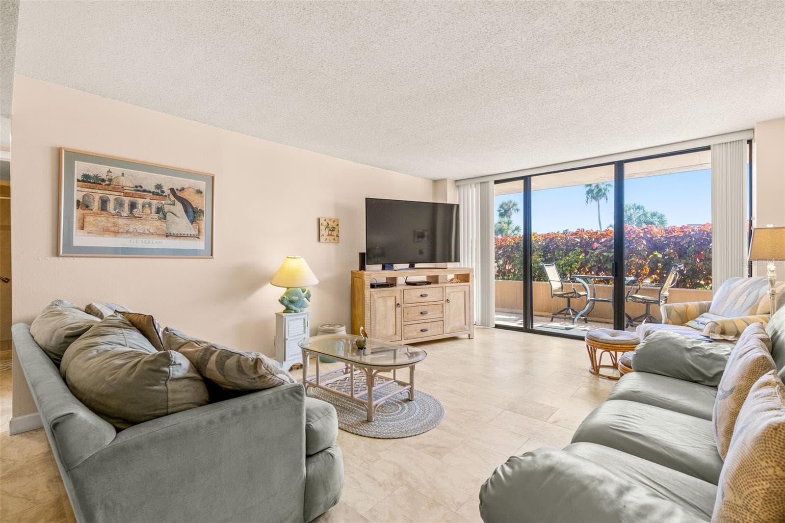 Living Room View - also showing one of the three accesses to Patio and Plaza Deck - which leads directly to POOL. Spa, etc....no lobby, elevator or stairs needed! - 1 KEY CAPRI #102E, TREASURE ISLAND