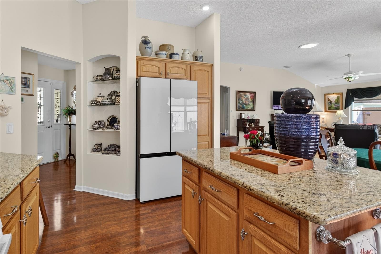 Detailed kitchen island featuring a generous amount of storage space, designed to efficiently organize and maximize the functionality of the kitchen area. - 1147 ELIZABETH CT, THE VILLAGES
