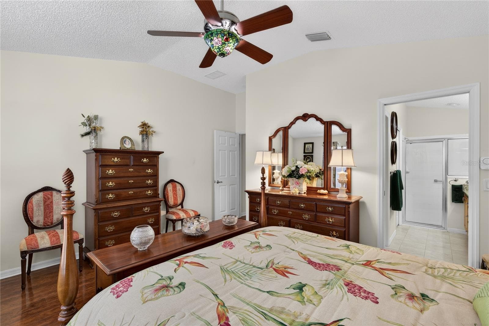Upgraded ceiling fan with Tiffany light shade. This fixture adds a touch of elegance and character to the space, combining functionality with beautiful design elements. - 1147 ELIZABETH CT, THE VILLAGES