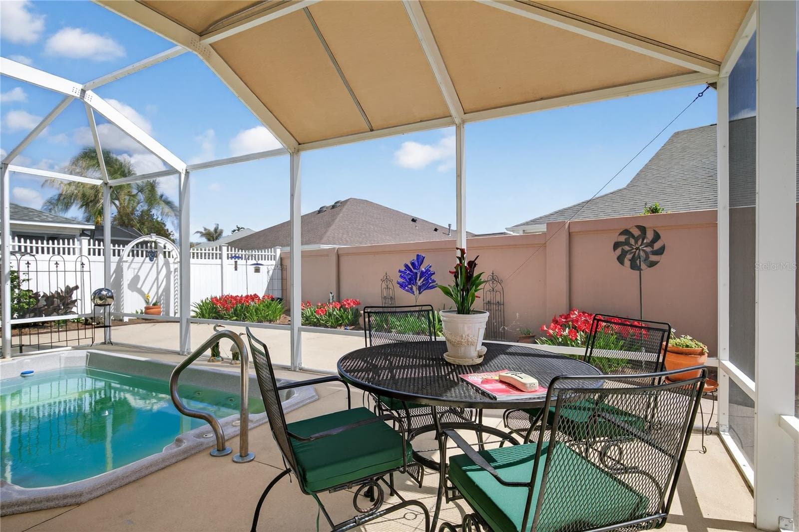 THE HEATED SWIM SPA IS SCREENED IN AND HAS A CANOPY FOR ADDED SHADE - 1147 ELIZABETH CT, THE VILLAGES