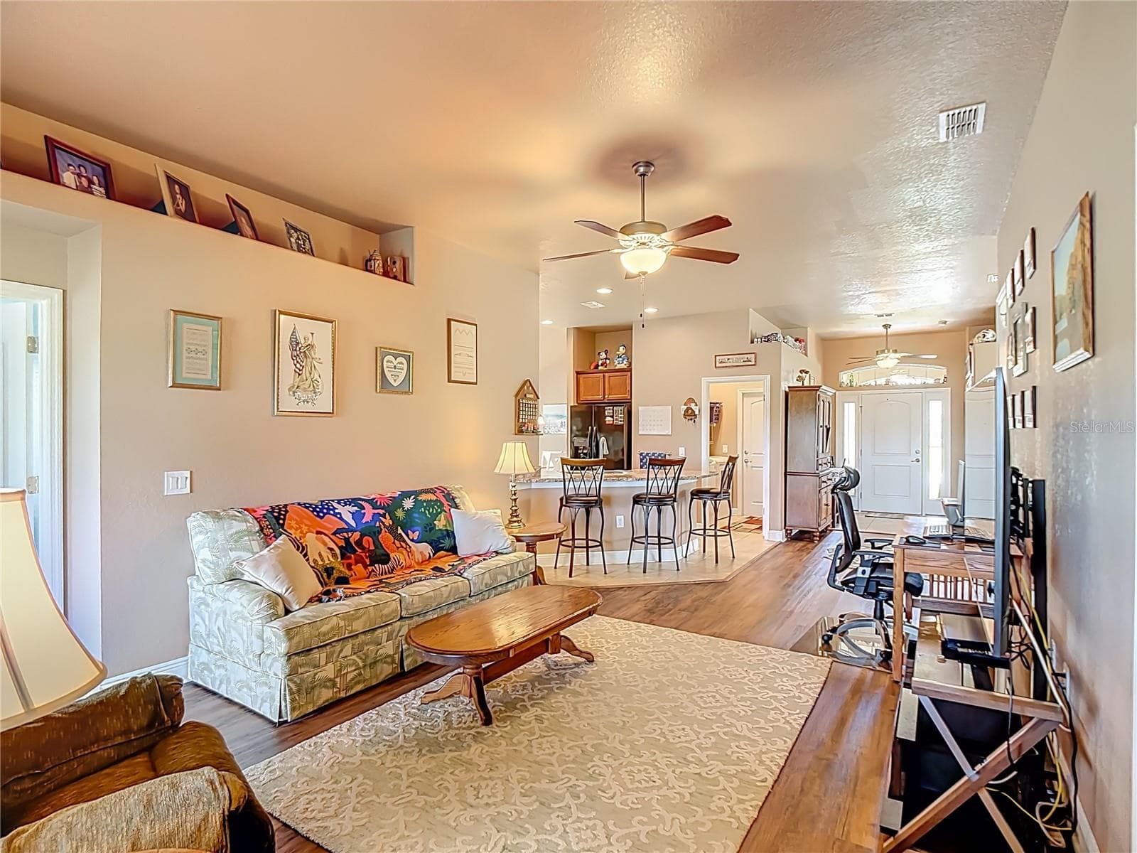 Looking from the living room to the breakfast bar and the front door with transom windows on either side of the door and the top of the door. - 1170 LEGATTO LOOP, DUNDEE