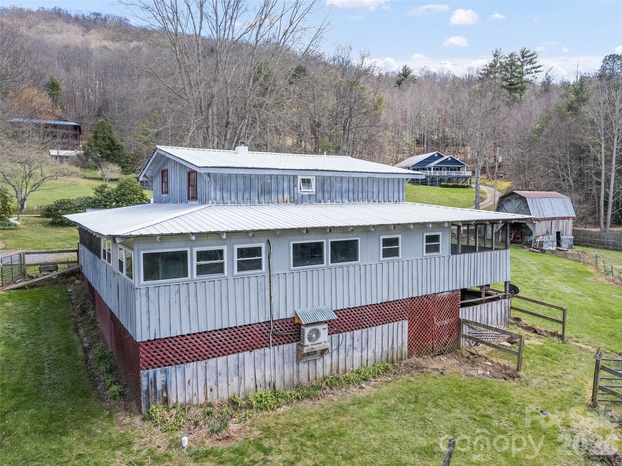 View of backside of house with basement entrance on right - Clyde