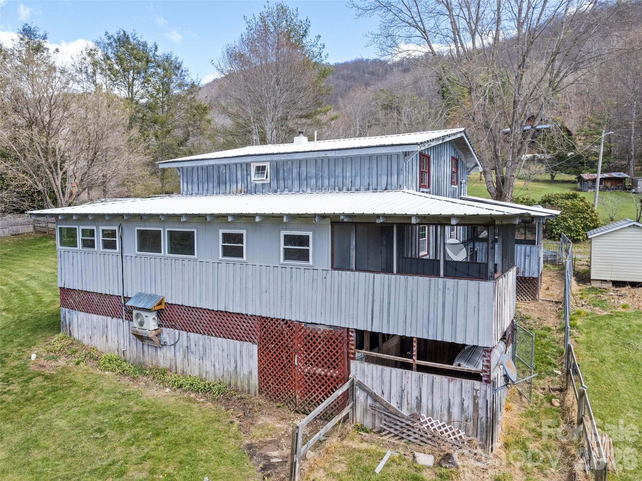 View of backside of house with basement entrance - Clyde