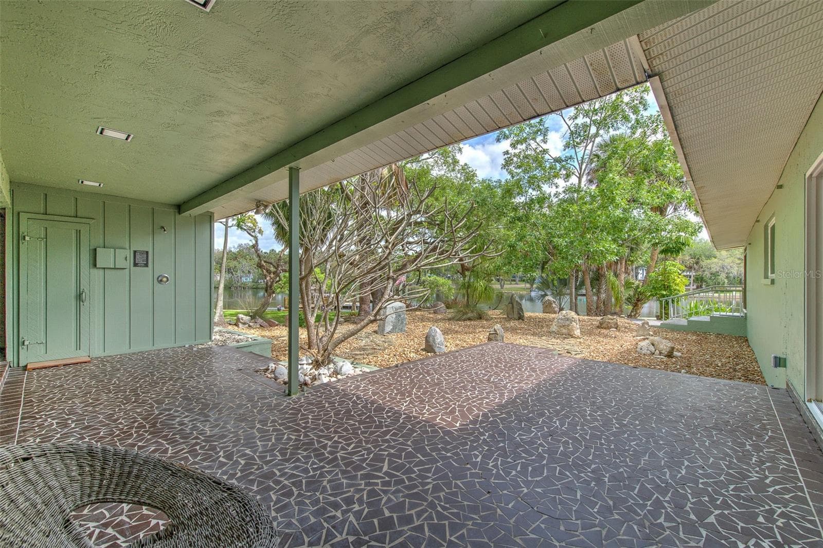 View of Sauna , rock garden & water from outside Master Bedroo - 7102 MANDY LN, NEW PORT RICHEY