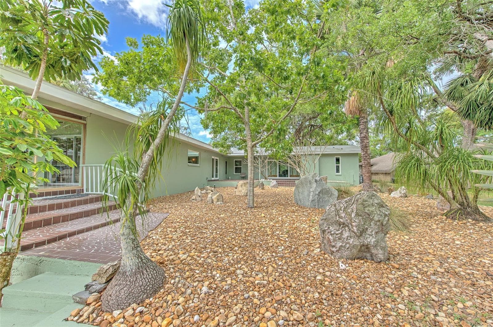 Backyard views of home & rock garden - 7102 MANDY LN, NEW PORT RICHEY