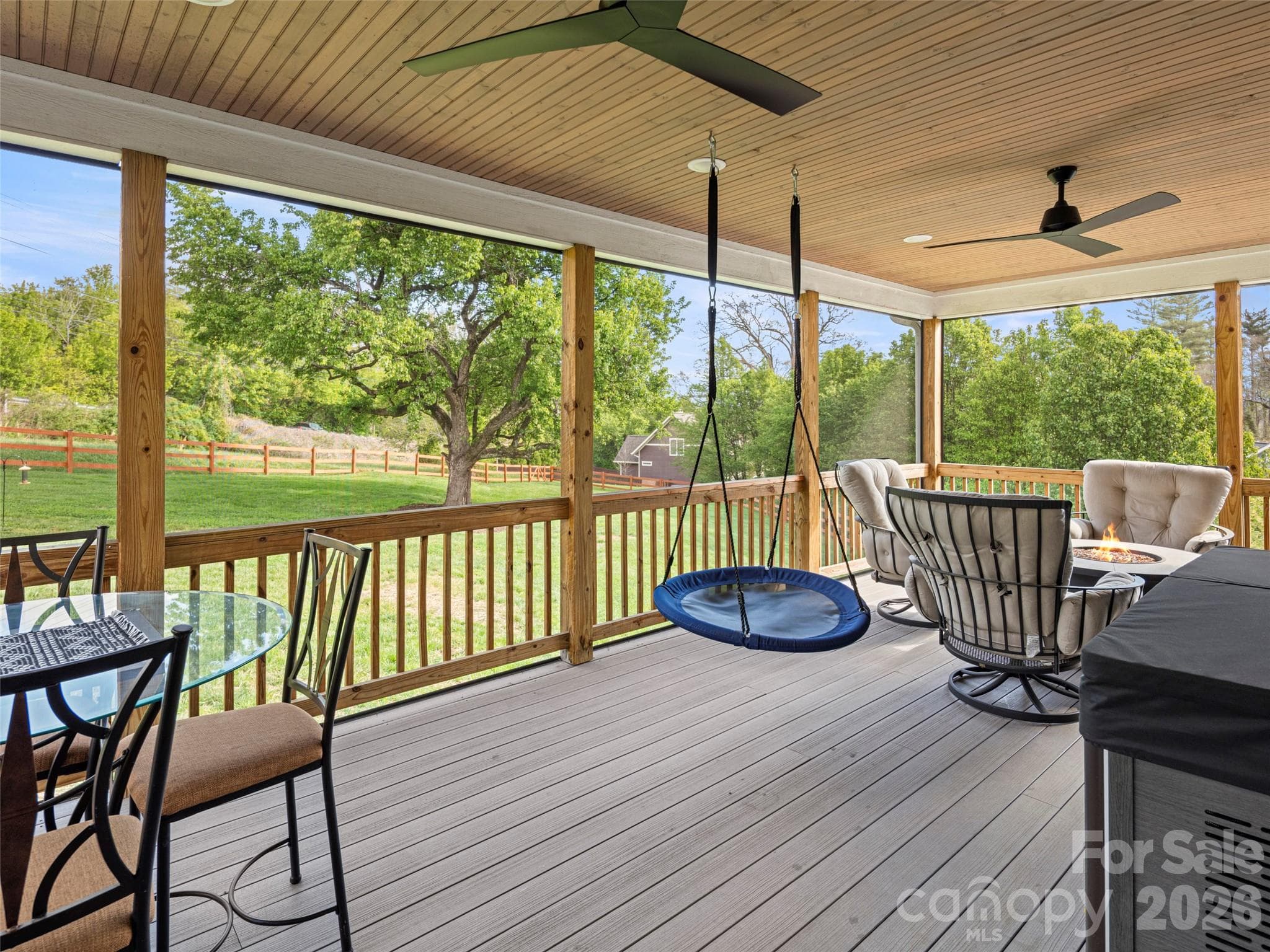 Enjoy bug-free evenings on your screened porch, overlooking your generously-sized, fully fenced corner lot - 127 Rockbridge Road, Mills River