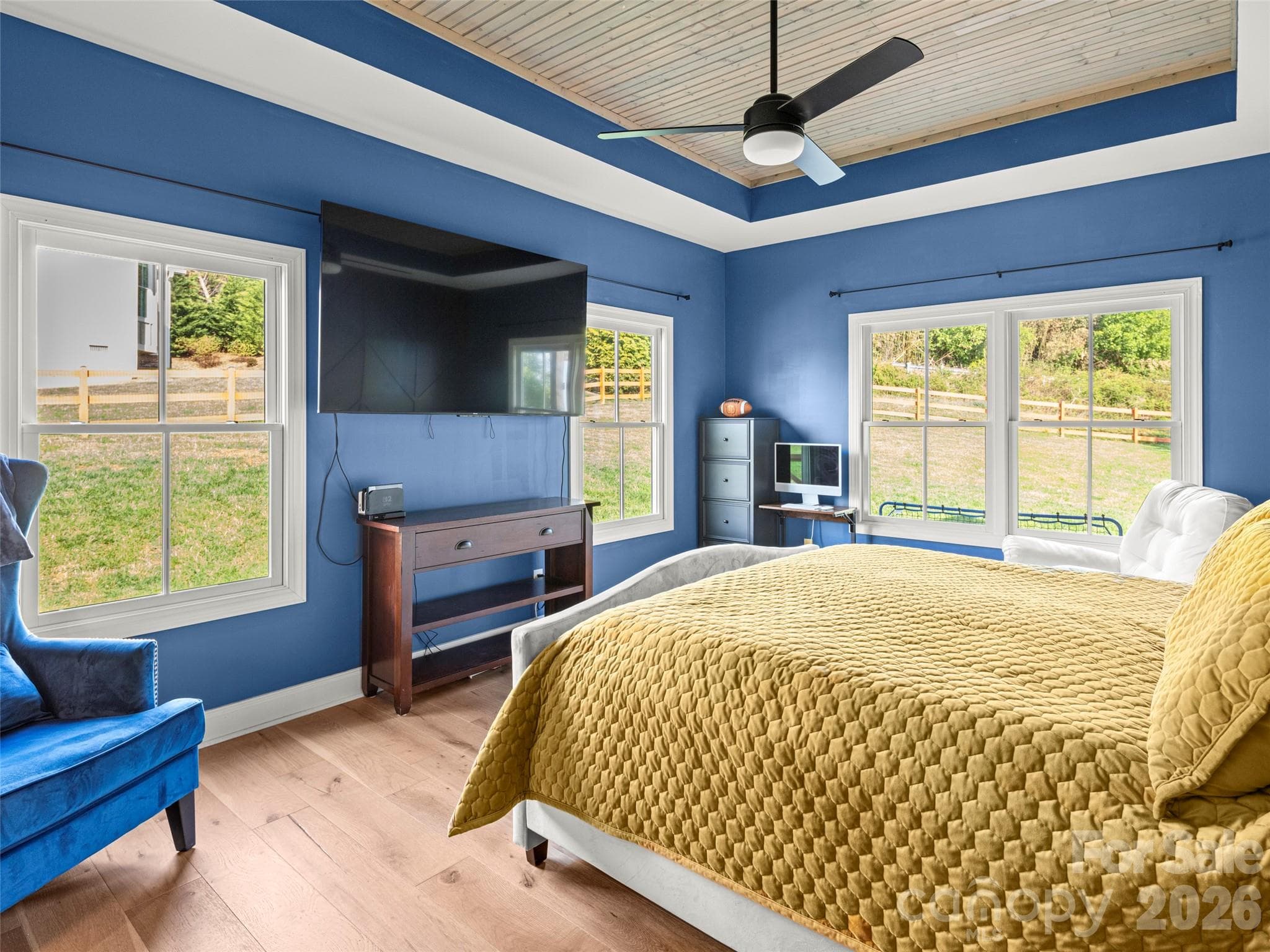 Updated primary bedroom features abundant light and stunning tray ceiling - 127 Rockbridge Road, Mills River