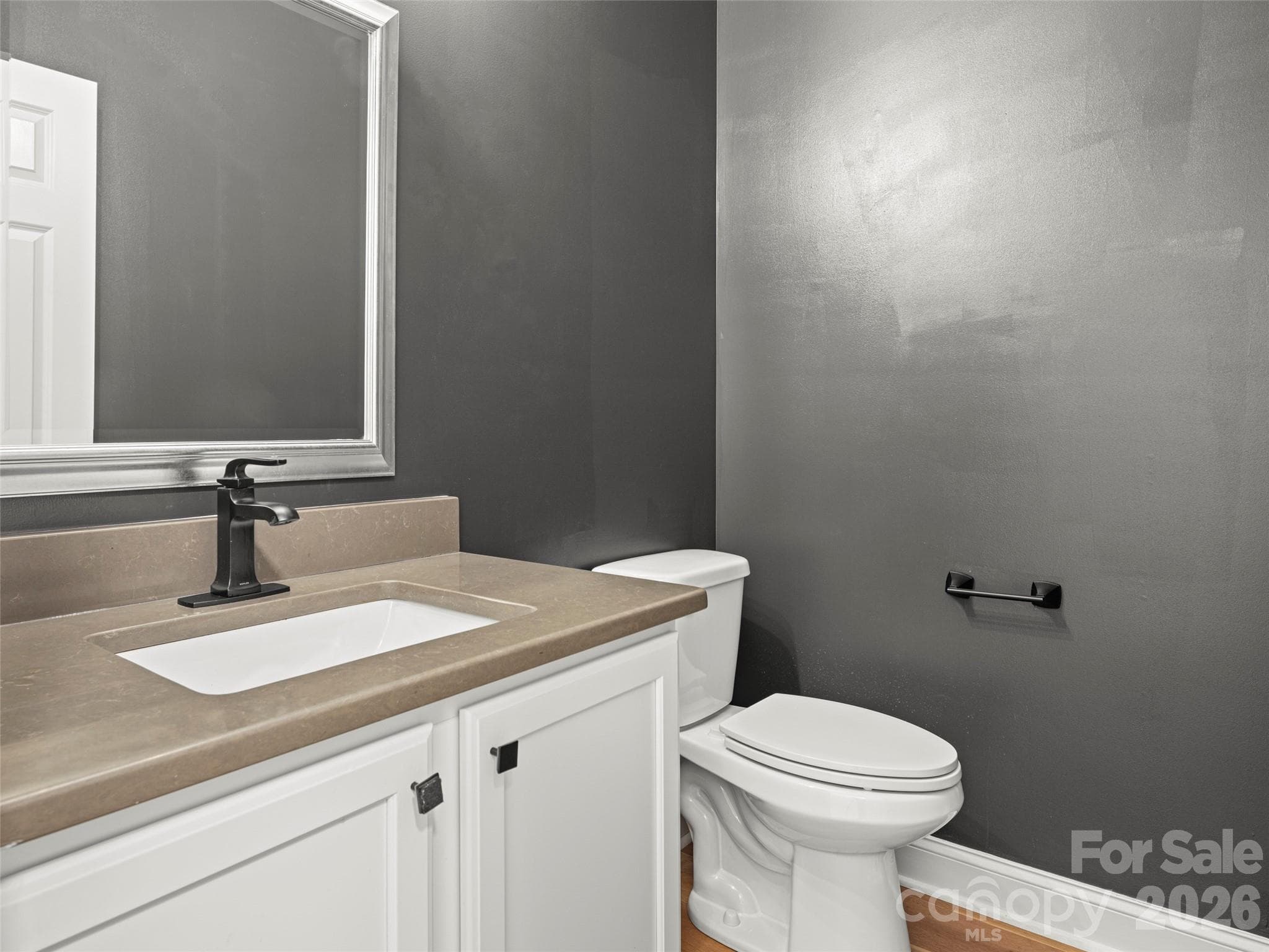 Half bath with updated fixtures and fresh paint - 127 Rockbridge Road, Mills River
