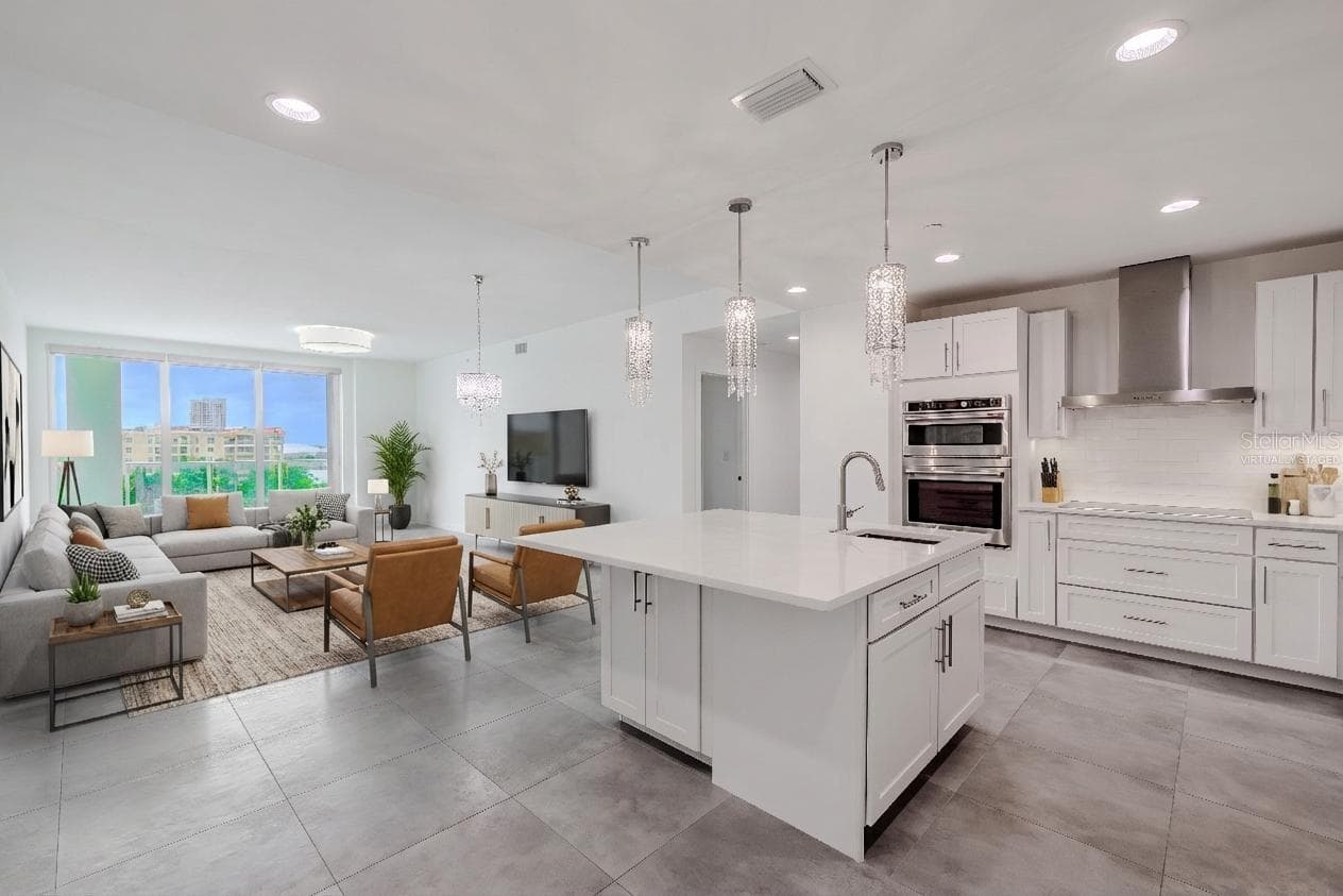 Perched on the 7th floor of Marina Bay 880, this 3-bedroom, 4-bath luxury penthouse-style residence showcases stunning panoramic views of the Intracoastal Waterway and marina below. Designed for refined coastal living, the residence includes two assigned parking spaces (#88 and #45) within a secure garage for added convenience. Virtually staged photo. - 920 N OSCEOLA AVE #703, CLEARWATER