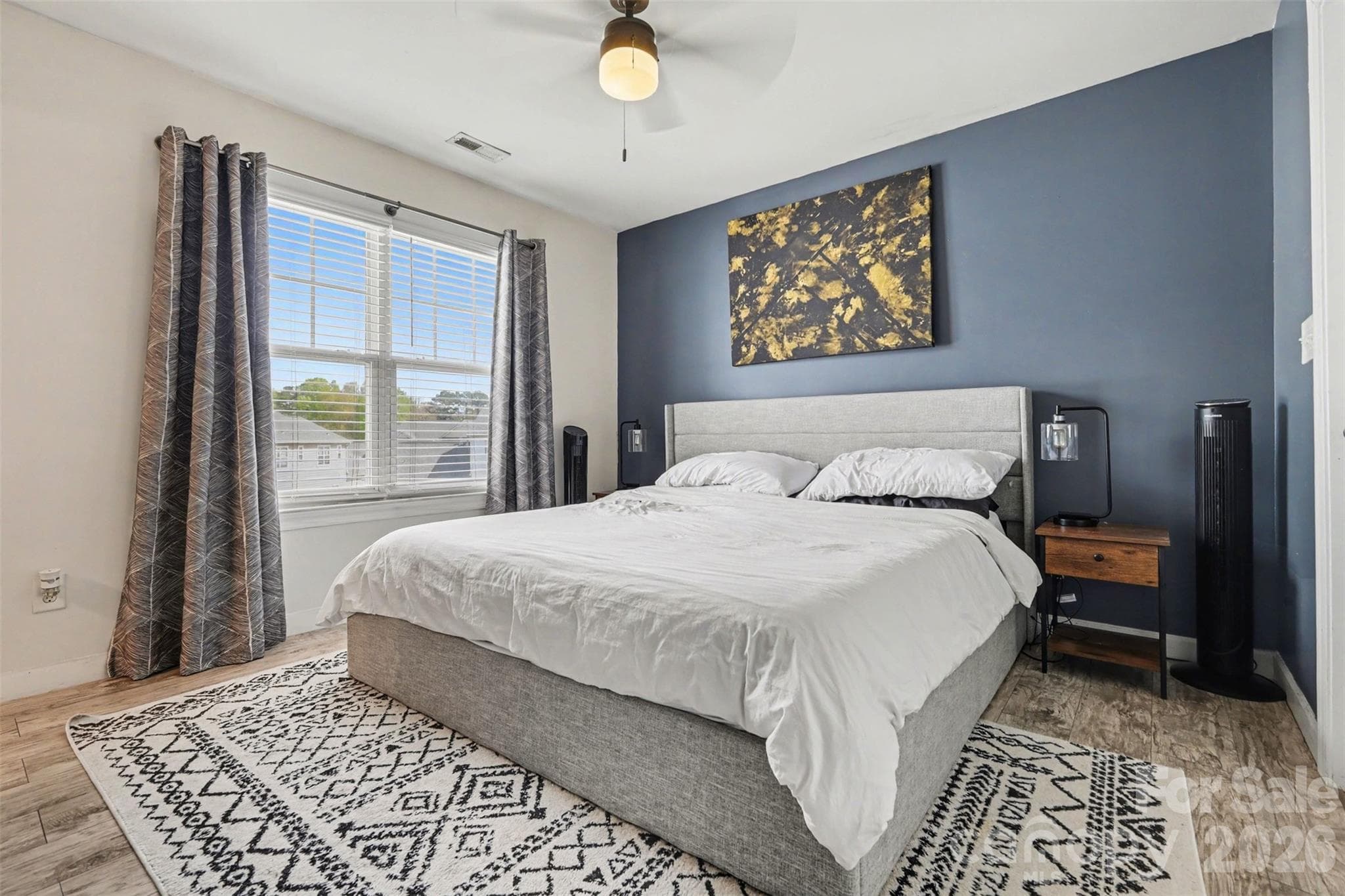 Spacious primary bedroom featuring updated LVP flooring throughout the upper level and a generous walk-in closet for added storage and convenience. - 2729 Avalon Loop Road, Charlotte