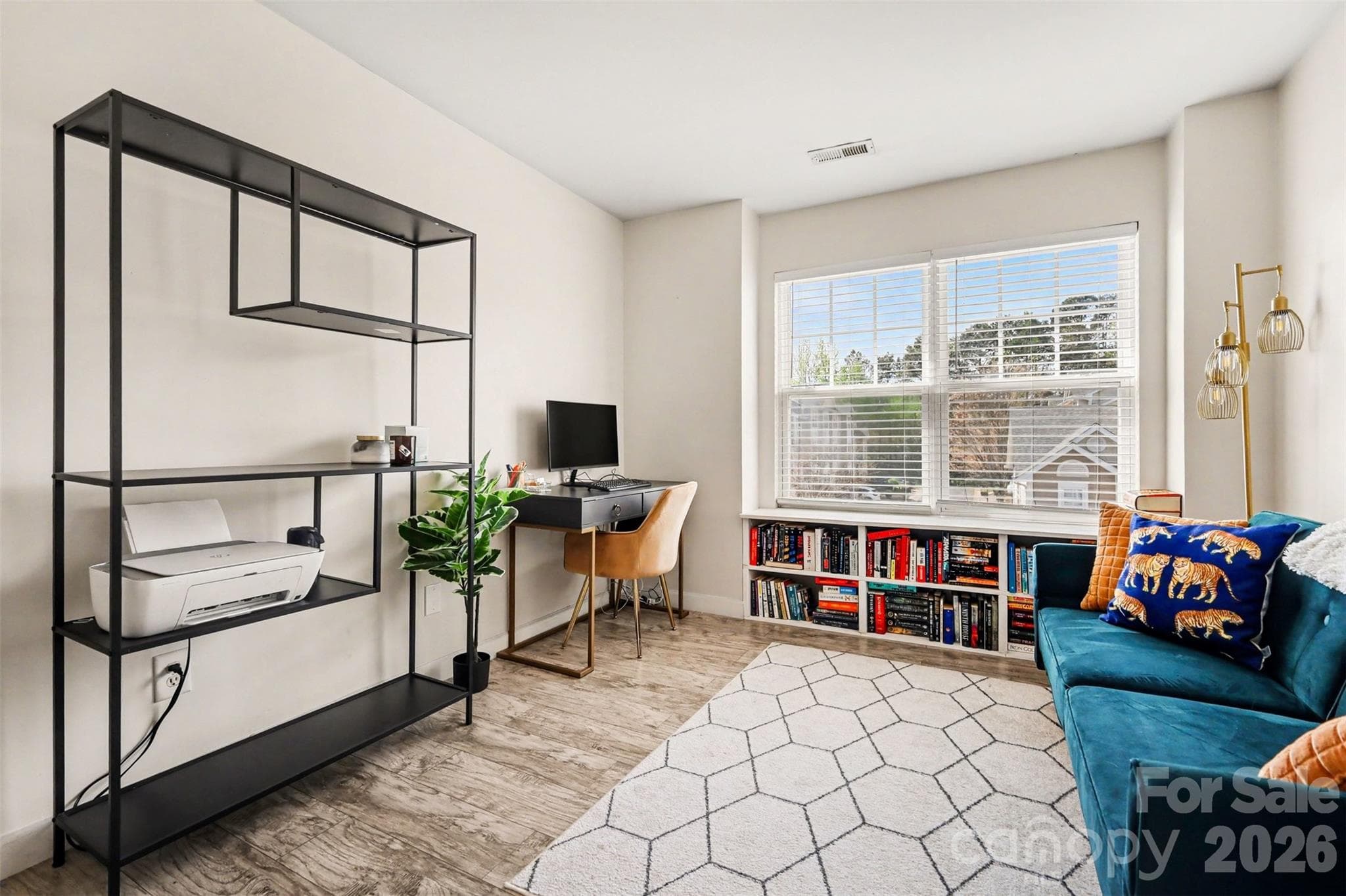 Bright secondary bedroom featuring large front-facing windows that fill the space with natural light. - 2729 Avalon Loop Road, Charlotte