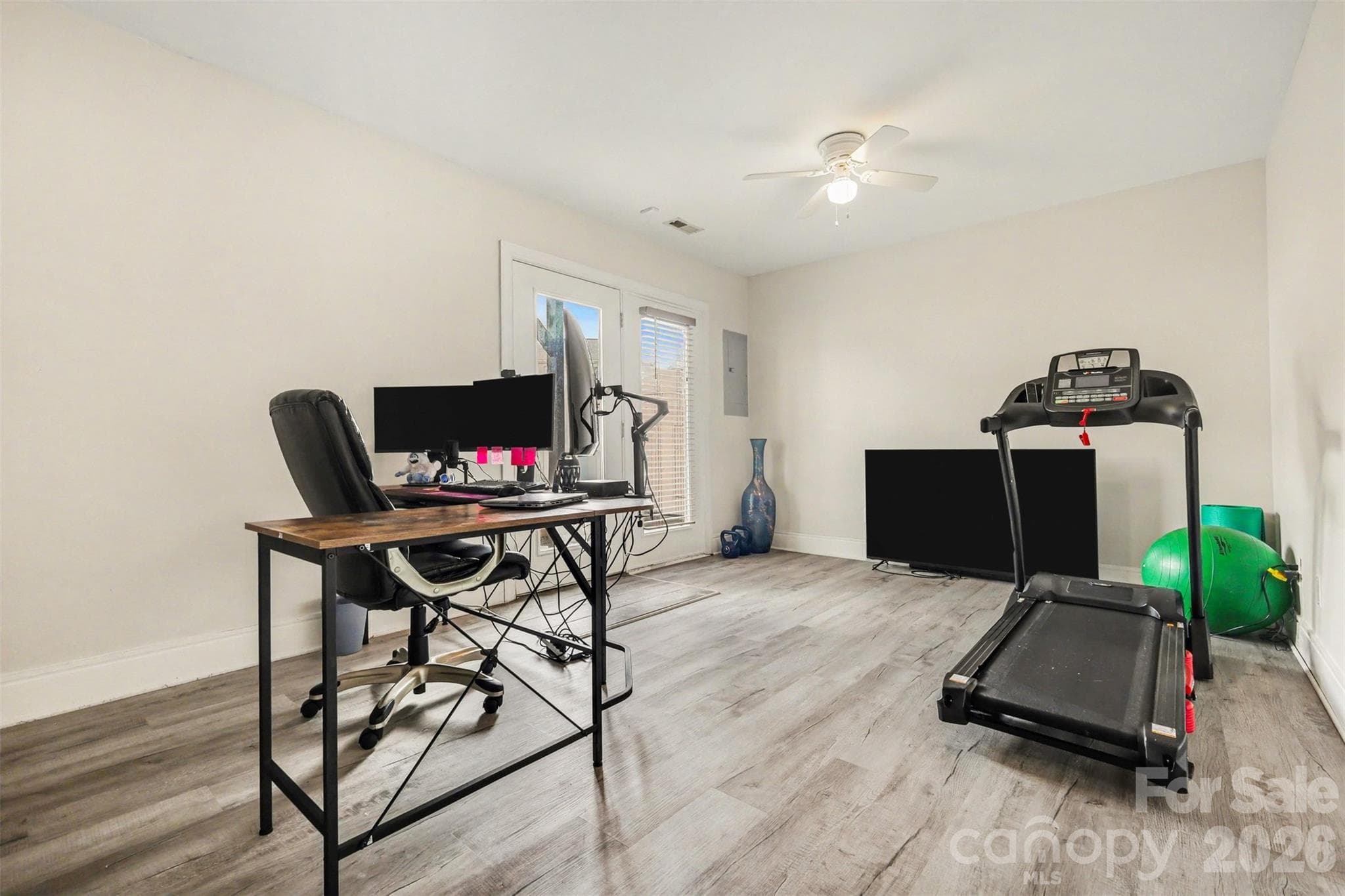 Versatile lower-level bonus space with direct access to the private patio, offering the perfect area for a home office, gym, or additional living space. - 2729 Avalon Loop Road, Charlotte