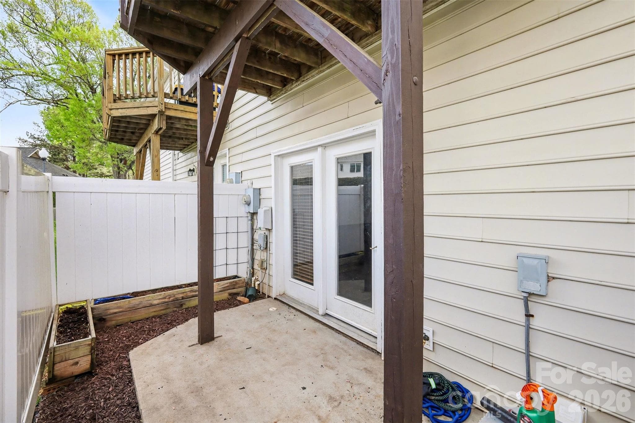 Private lower-level patio accessible from the bonus room, offering a fenced outdoor retreat perfect for relaxing or entertaining. - 2729 Avalon Loop Road, Charlotte
