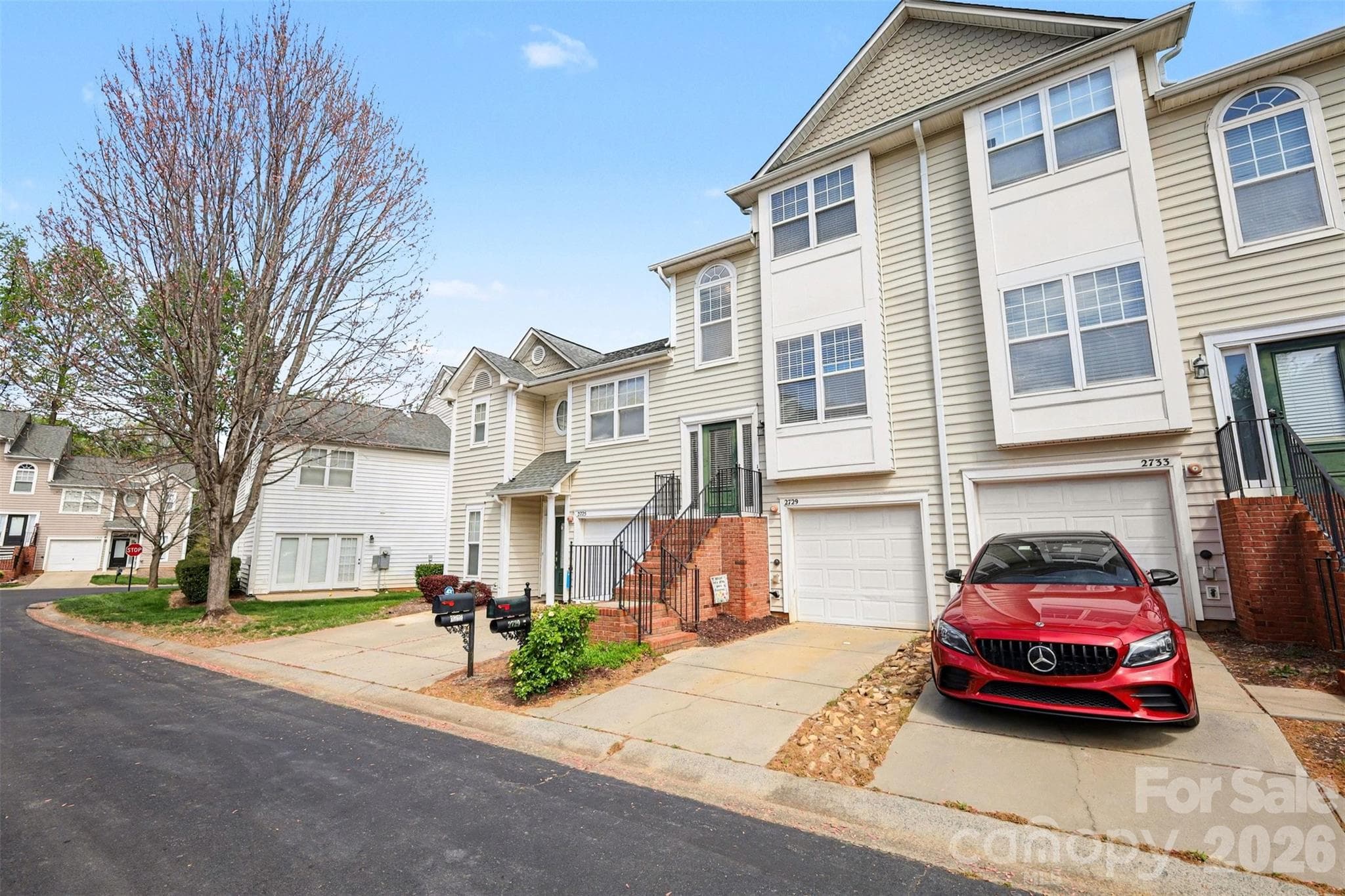 Attached one-car garage with private driveway parking, plus convenient guest parking nearby. - 2729 Avalon Loop Road, Charlotte