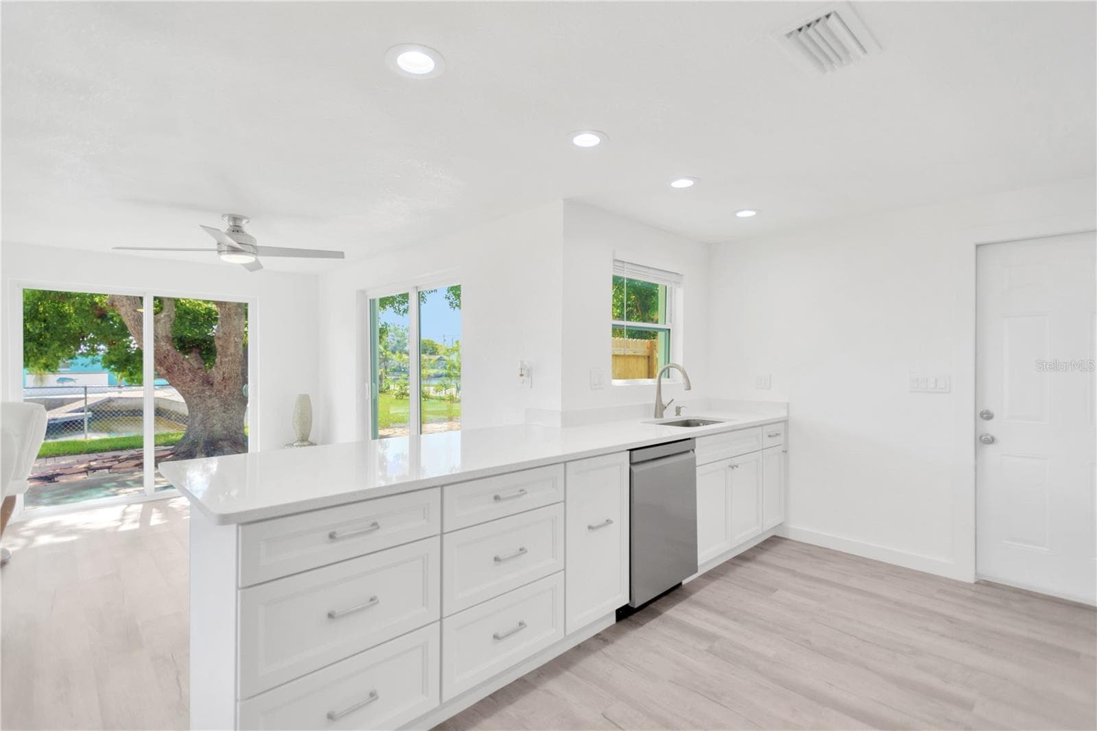 Enjoy the panaromic water view and green space as you work in the kitchen.  Preparing meals is a joy with the abundance of counter space and cabinets available to you. - 13724 COX AVE, HUDSON