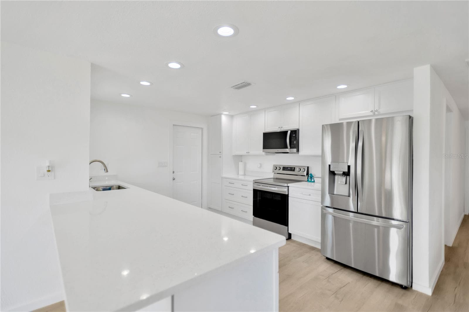 Sparkle Quartz countertops make this kitchen shine with elegance.  New LG appliances complete this dream kitchen. - 13724 COX AVE, HUDSON