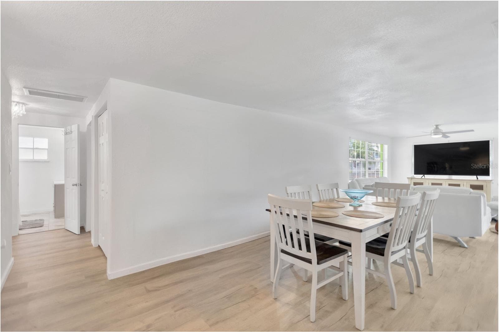 Looking from the dining area into the Living Room.  Blank wall space provides an opportunity to showcase your favorite artwork or enhance with the perfect dining room Hutch to complete the "Look". - 13724 COX AVE, HUDSON