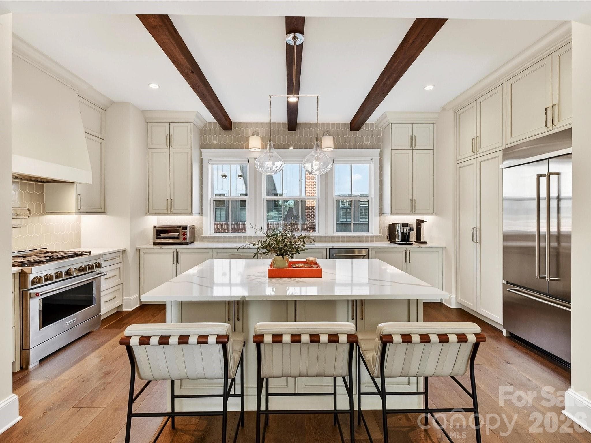 Stunning kitchen with HUGE island, wood beam accents, stainless steel appliances with built-in refrigerator, 6 burner gas range - Charlotte